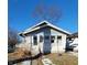 Light blue bungalow with white brick accents and small front yard at 710 N Drexel Ave, Indianapolis, IN 46201