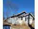 Side view of a light blue bungalow with visible yard and tree at 710 N Drexel Ave, Indianapolis, IN 46201