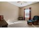Bright bedroom with window, rocking chair and ottoman at 7710 Silver Moon Way, Indianapolis, IN 46259