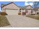 Brick ranch home with attached garage and driveway at 7710 Silver Moon Way, Indianapolis, IN 46259