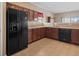 Modern kitchen with black appliances and wood cabinets at 7710 Silver Moon Way, Indianapolis, IN 46259