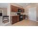 Clean kitchen with dark wood cabinets and black appliances at 7710 Silver Moon Way, Indianapolis, IN 46259