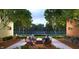 Outdoor firepit area with seating, surrounded by trees and brick buildings at 9891 Sunbranch Dr, Carmel, IN 46290