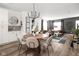 Open concept dining area with wood table and modern chandelier at 9891 Sunbranch Dr, Carmel, IN 46290