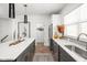 Modern kitchen with dark cabinetry, quartz countertops, and stainless steel appliances at 9891 Sunbranch Dr, Carmel, IN 46290