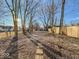 Large backyard with mature trees and a stone path at 1014 N Sheffield Ave, Indianapolis, IN 46222