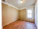 Simple bedroom with hardwood floors and a window at 1014 N Sheffield Ave, Indianapolis, IN 46222