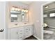 Bathroom with double vanity, white cabinets, and mirror at 11722 Platt St, Noblesville, IN 46060
