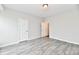 Bright bedroom featuring wood-look floors and an open door to hallway at 11722 Platt St, Noblesville, IN 46060