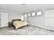 Primary bedroom with wood-look floors and multiple windows at 11722 Platt St, Noblesville, IN 46060