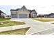 Two-story home with gray brick exterior and a three-car garage at 11722 Platt St, Noblesville, IN 46060
