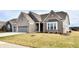 Two-story home with gray brick exterior and a three-car garage at 11722 Platt St, Noblesville, IN 46060