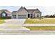 Two-story home with gray brick exterior and a three-car garage at 11722 Platt St, Noblesville, IN 46060
