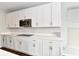 White kitchen cabinets, quartz countertops, and stainless steel appliances at 11722 Platt St, Noblesville, IN 46060