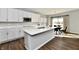 Island kitchen with white cabinets, quartz countertops and stainless steel appliances at 11722 Platt St, Noblesville, IN 46060