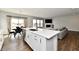 Island kitchen with white cabinets, quartz countertops, and stainless steel appliances at 11722 Platt St, Noblesville, IN 46060