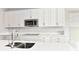 White kitchen cabinets, quartz countertops, and stainless steel appliances at 11722 Platt St, Noblesville, IN 46060