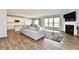 Open living room with hardwood floors, fireplace and kitchen view at 11722 Platt St, Noblesville, IN 46060