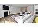 Living room with sectional sofa, fireplace, and hardwood floors at 11722 Platt St, Noblesville, IN 46060