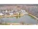 An aerial view of homes surrounding a pond and community area at 1229 Tealpoint Cir, Indianapolis, IN 46229