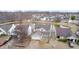 An aerial shot showcases a single-Gathering home with a pond in the residential area at 1229 Tealpoint Cir, Indianapolis, IN 46229