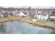Aerial view of a home with a backyard, shed, and access to the community pond at 1229 Tealpoint Cir, Indianapolis, IN 46229