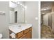 Neutral bathroom with a mirror over the sink with drawers and a tile floor at 1229 Tealpoint Cir, Indianapolis, IN 46229
