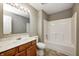 Bathroom with a wooden vanity, mirror, and a shower-tub combo at 1229 Tealpoint Cir, Indianapolis, IN 46229