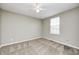 Bright bedroom with a ceiling fan and window, neutral paint and carpet at 1229 Tealpoint Cir, Indianapolis, IN 46229