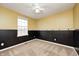 Bedroom featuring yellow upper walls, black lower walls, and a window at 1229 Tealpoint Cir, Indianapolis, IN 46229
