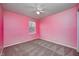 A bedroom with pink walls, a ceiling fan, and a carpeted floor at 1229 Tealpoint Cir, Indianapolis, IN 46229
