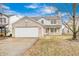 Charming two-story home features an attached garage, a welcoming front porch, and well-maintained landscaping at 1229 Tealpoint Cir, Indianapolis, IN 46229