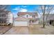 Two-story home with a brick facade, two-car garage, and charming front porch at 1229 Tealpoint Cir, Indianapolis, IN 46229