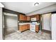 Well-lit kitchen showcasing wood cabinets, white appliances, and tile flooring at 1229 Tealpoint Cir, Indianapolis, IN 46229