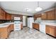 Open kitchen with wood cabinets, white countertops, and modern appliances at 1229 Tealpoint Cir, Indianapolis, IN 46229