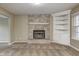 Bright living room featuring a brick fireplace, built-in shelving, and a large window at 1229 Tealpoint Cir, Indianapolis, IN 46229