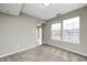 Spacious living room featuring neutral walls, plush carpeting, and large windows for ample natural light at 1229 Tealpoint Cir, Indianapolis, IN 46229