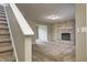 Cozy living room with a brick fireplace, plush carpet, and staircase at 1229 Tealpoint Cir, Indianapolis, IN 46229