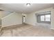 Open-concept living room with neutral walls, plush carpeting, and abundant natural light at 1229 Tealpoint Cir, Indianapolis, IN 46229