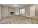 Inviting living room with a brick fireplace, built-in shelving, and neutral carpet at 1229 Tealpoint Cir, Indianapolis, IN 46229