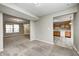 Open living area with neutral walls, plush carpeting, and seamless access to the adjacent kitchen at 1229 Tealpoint Cir, Indianapolis, IN 46229