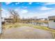 Concrete patio featuring a water view with mature trees and a black fence at 1229 Tealpoint Cir, Indianapolis, IN 46229