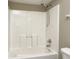 A tub shower with off-white tub, shower head, and handle with toilet on the right at 1229 Tealpoint Cir, Indianapolis, IN 46229