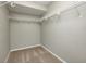 Neutral walls and carpet in a walk-in closet featuring wire shelving and clothing racks at 1229 Tealpoint Cir, Indianapolis, IN 46229