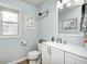 Charming half bathroom with blue walls, and a white vanity at 1295 Longleaf St, Avon, IN 46123
