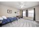 Inviting bedroom featuring two bright windows, a ceiling fan and comfortable carpet at 1295 Longleaf St, Avon, IN 46123