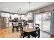 Modern kitchen with stainless steel appliances, a kitchen island, and a breakfast nook with barstool seating at 1295 Longleaf St, Avon, IN 46123