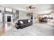 Bright and airy living room connects to a staircase and kitchen area, featuring a comfortable leather sofa at 1295 Longleaf St, Avon, IN 46123