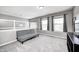 Cozy living room with plush carpet, gray futon, and large windows providing natural light and pleasant views at 1295 Longleaf St, Avon, IN 46123