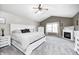 Spacious main bedroom with a fireplace, vaulted ceilings, and a large bed bathed in natural light at 1295 Longleaf St, Avon, IN 46123